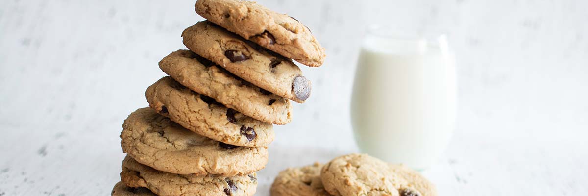 stack of cookies with glass of milk