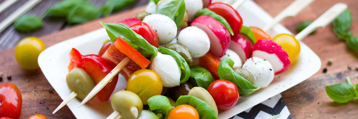 platter with raw vegetable, cheese and olive kabobs