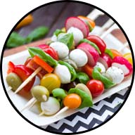 platter with raw vegetable, cheese and olive kabobs