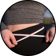 close up of woman with cloth tape measure around her waist
