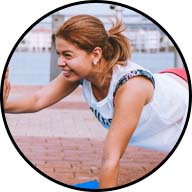 woman smiling while doing a push-up